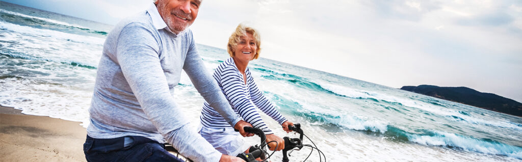 man and woman biking near beach