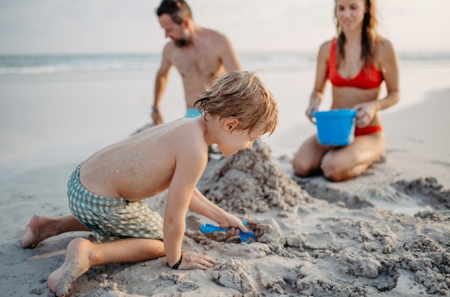 family playing in the sand